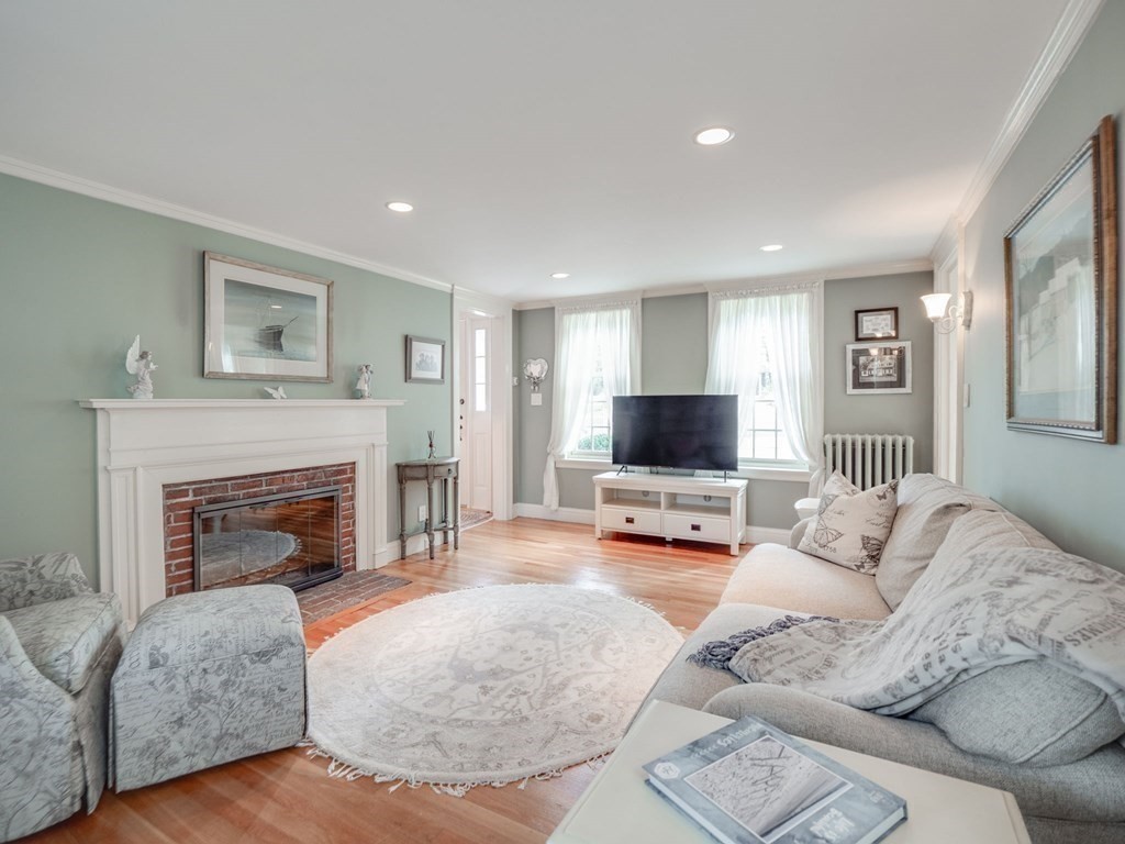 35 Pine Street Melrose, MA 02176 - Photo 13 of 38 a living room with furniture a fireplace and a flat screen tv