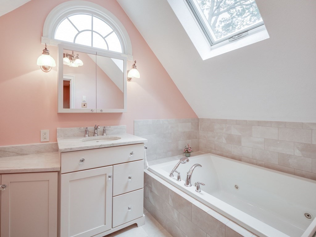 35 Pine Street Melrose, MA 02176 - Photo 18 of 38 a bathroom with a bathtub a sink and a window