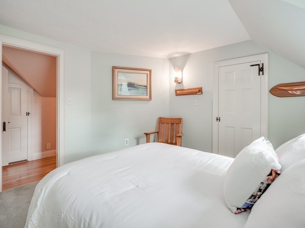 35 Pine Street Melrose, MA 02176 - Photo 25 of 38 a bedroom with a white bed and a chandelier