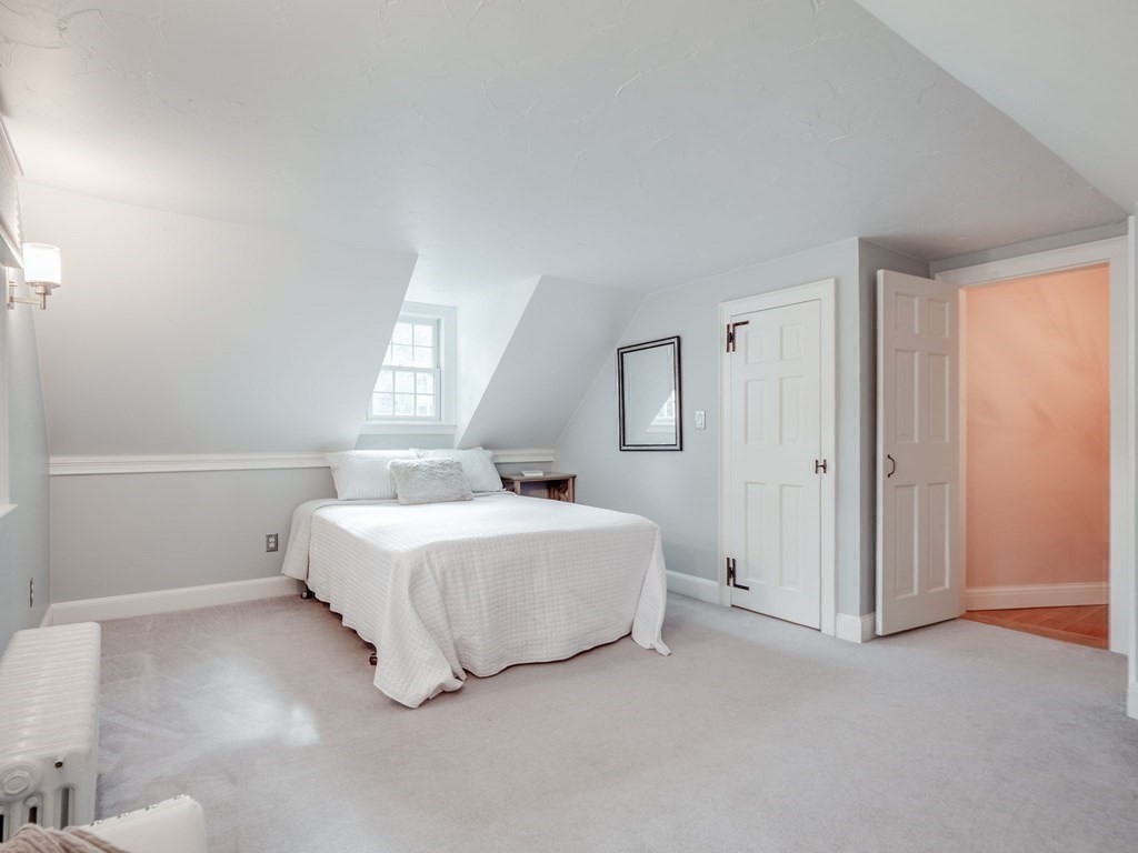 35 Pine Street Melrose, MA 02176 - Photo 27 of 38 a spacious bedroom with a bed and a window