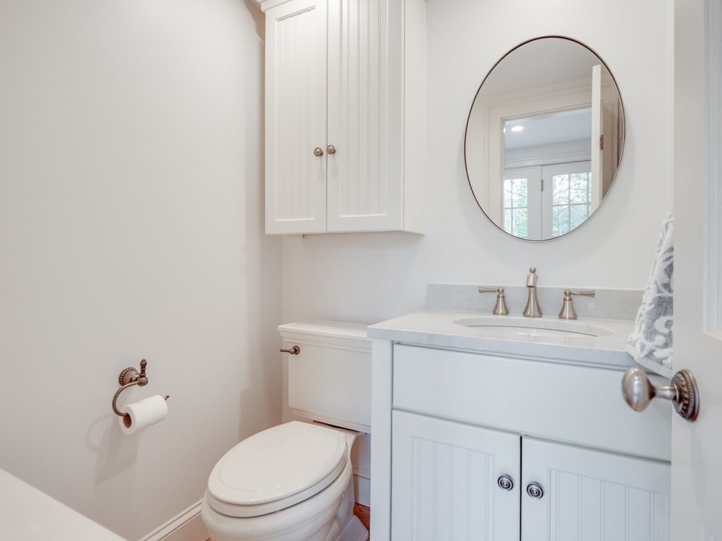 35 Pine Street Melrose, MA 02176 - Photo 7 of 38 a bathroom with a toilet a sink and a mirror