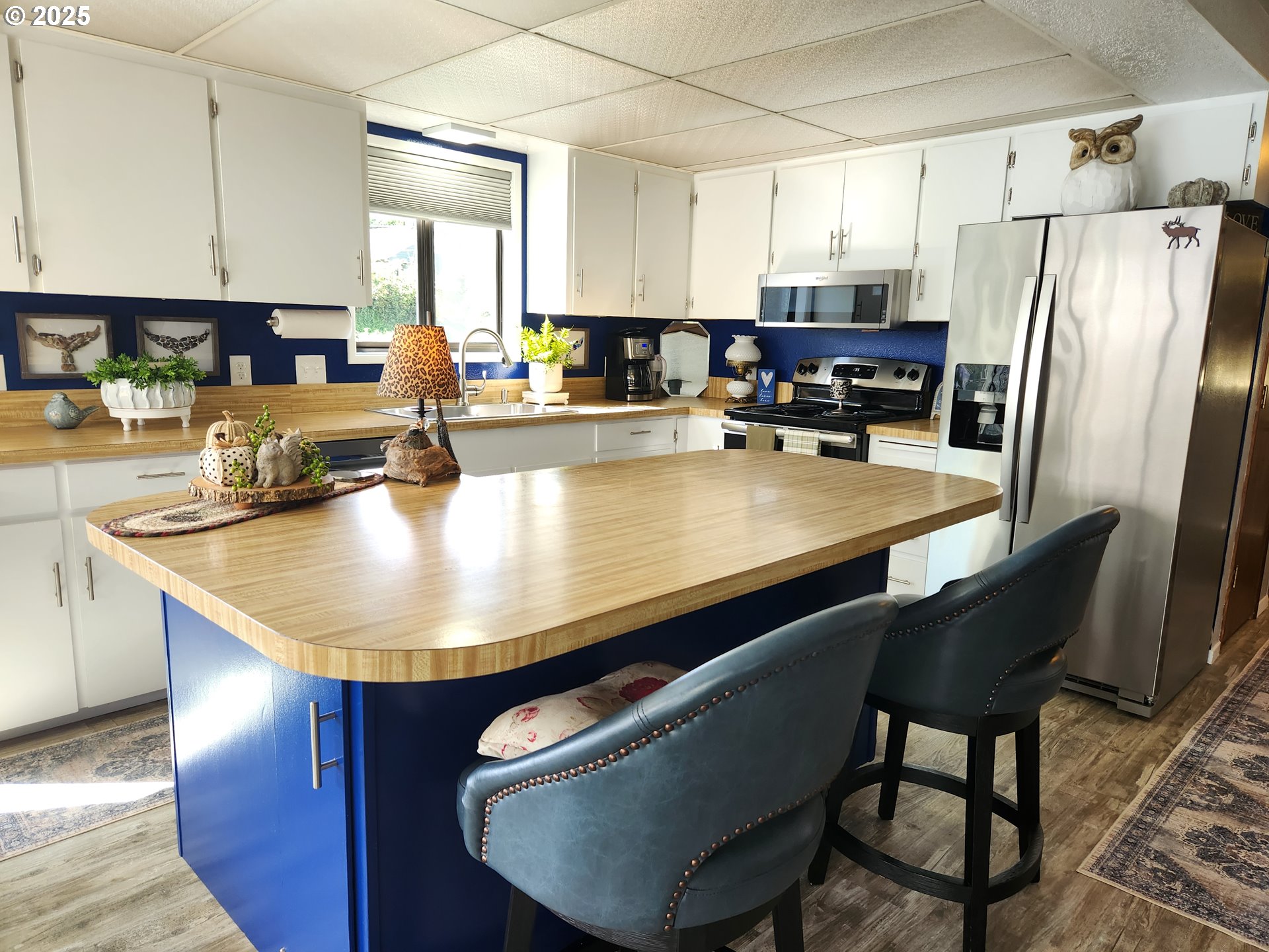 1144 Winchester Avenue Reedsport, OR 97467 - Photo 11 of 47 a kitchen with stainless steel appliances granite countertop a sink a table and chairs