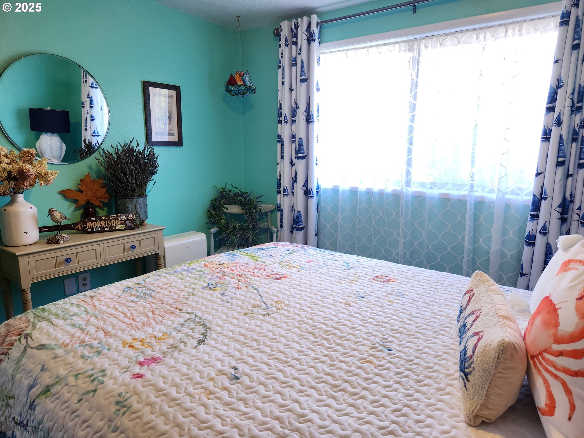1144 Winchester Avenue Reedsport, OR 97467 - Photo 24 of 47 a bedroom with a bed potted plants on dresser and a large window