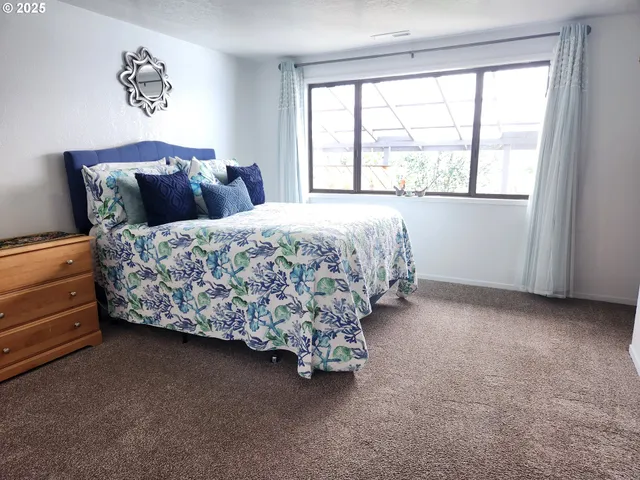 a bedroom with bed and a potted plant