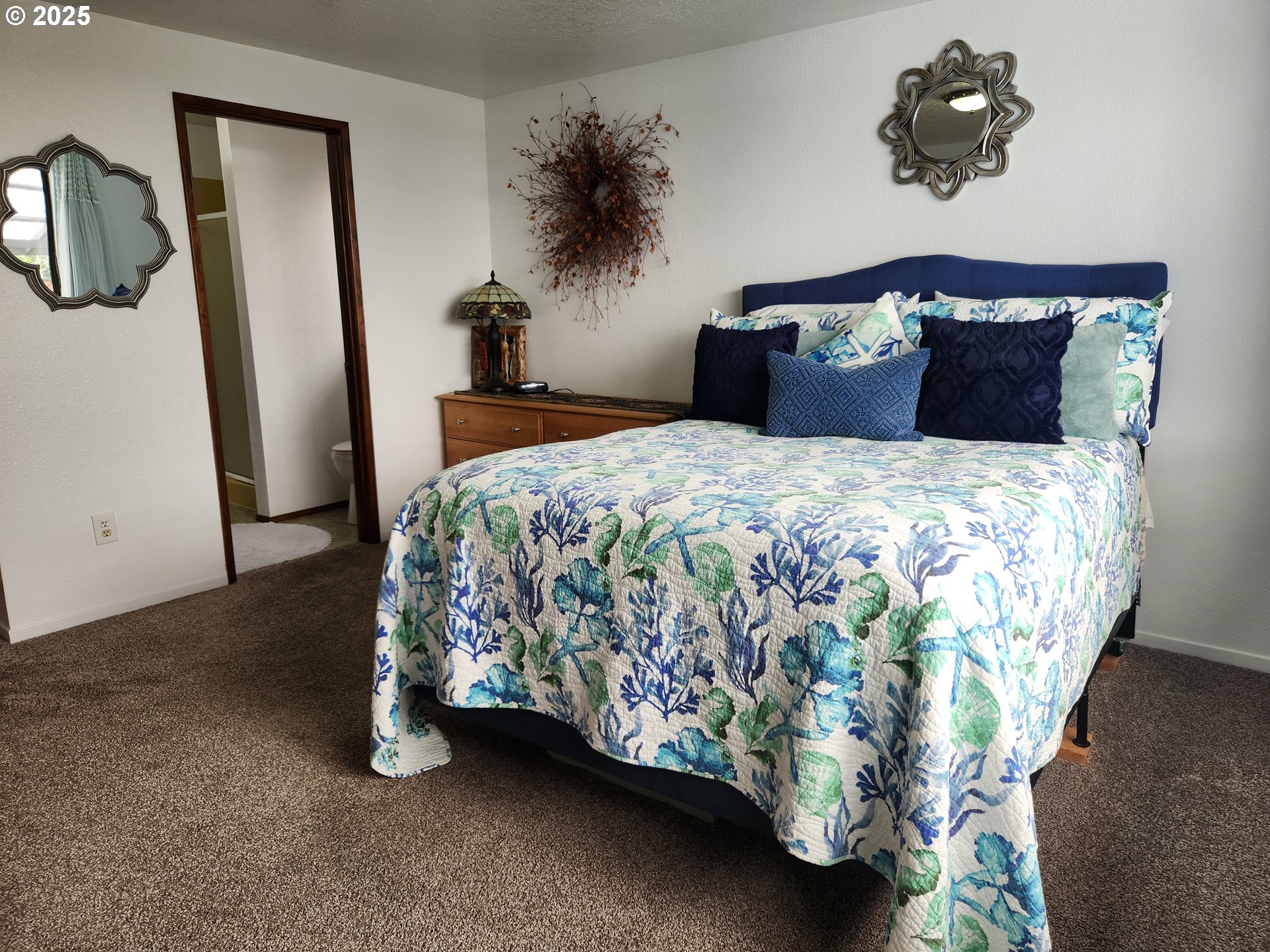 1144 Winchester Avenue Reedsport, OR 97467 - Photo 28 of 47 a bedroom with bed and a potted plant