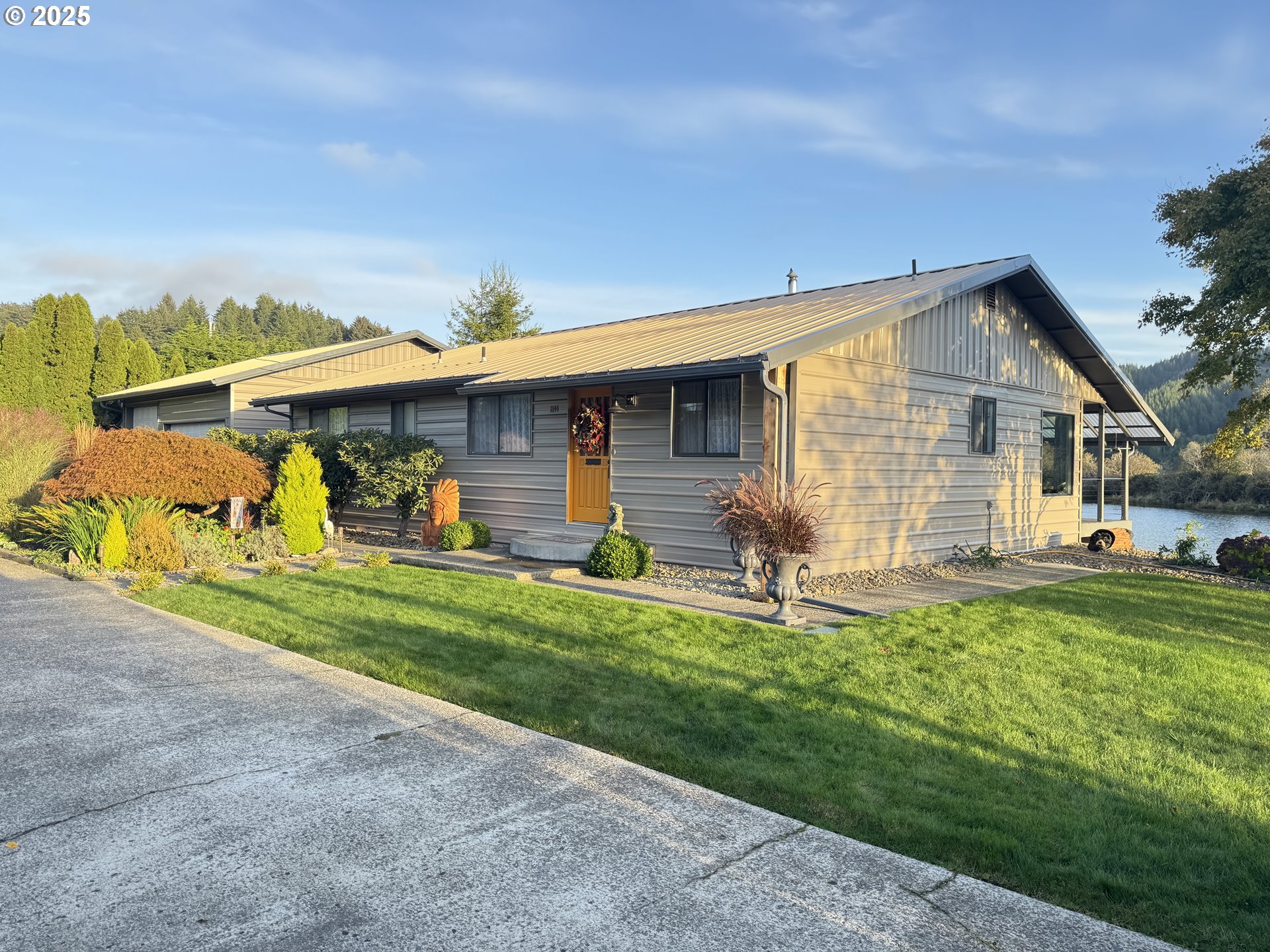 1144 Winchester Avenue Reedsport, OR 97467 - Photo 3 of 47 a front view of a house with a yard table and chairs