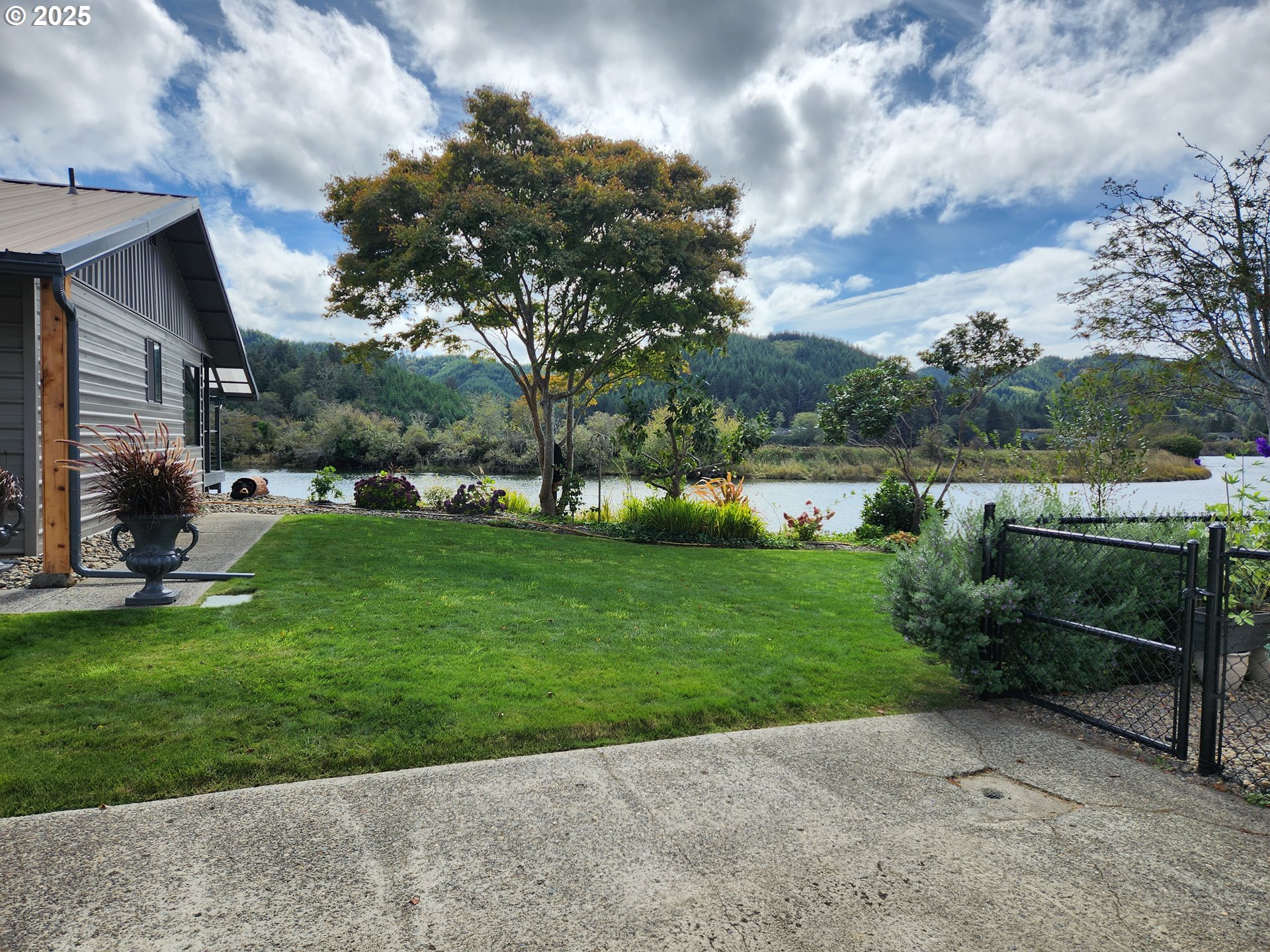 1144 Winchester Avenue Reedsport, OR 97467 - Photo 4 of 47 a view of a garden with an outdoor seating