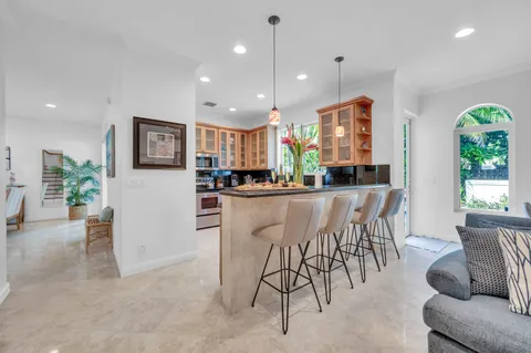a dining room with furniture and a kitchen view