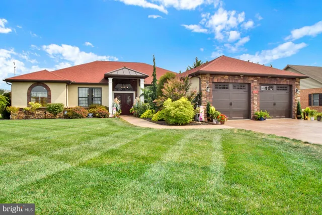 a front view of a house with a garden