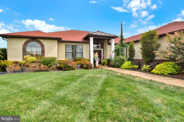 a front view of a house with garden