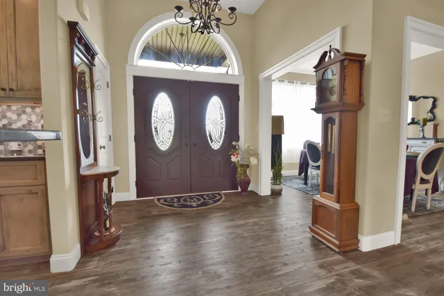 a view of a hallway with wooden floor and closet