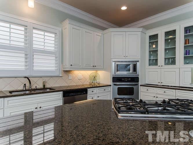 12221 Beestone Lane Raleigh, NC 27614 - Photo 5 of 25 a kitchen with stainless steel appliances granite countertop a stove sink and cabinets