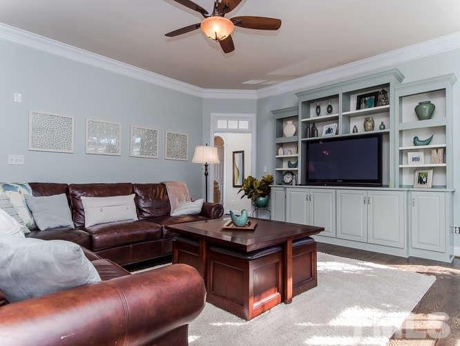 12221 Beestone Lane Raleigh, NC 27614 - Photo 8 of 25 a living room with furniture and a flat screen tv