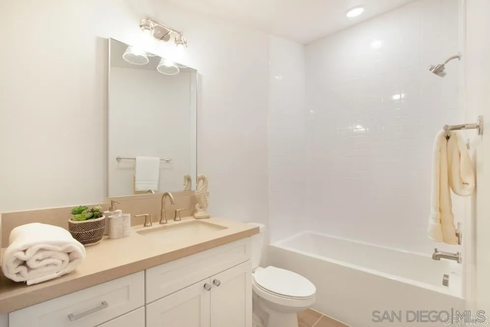 348 Walnut Avenue Carlsbad, CA 92008 - Photo 16 of 20 a bathroom with a granite countertop sink a toilet and bathtub