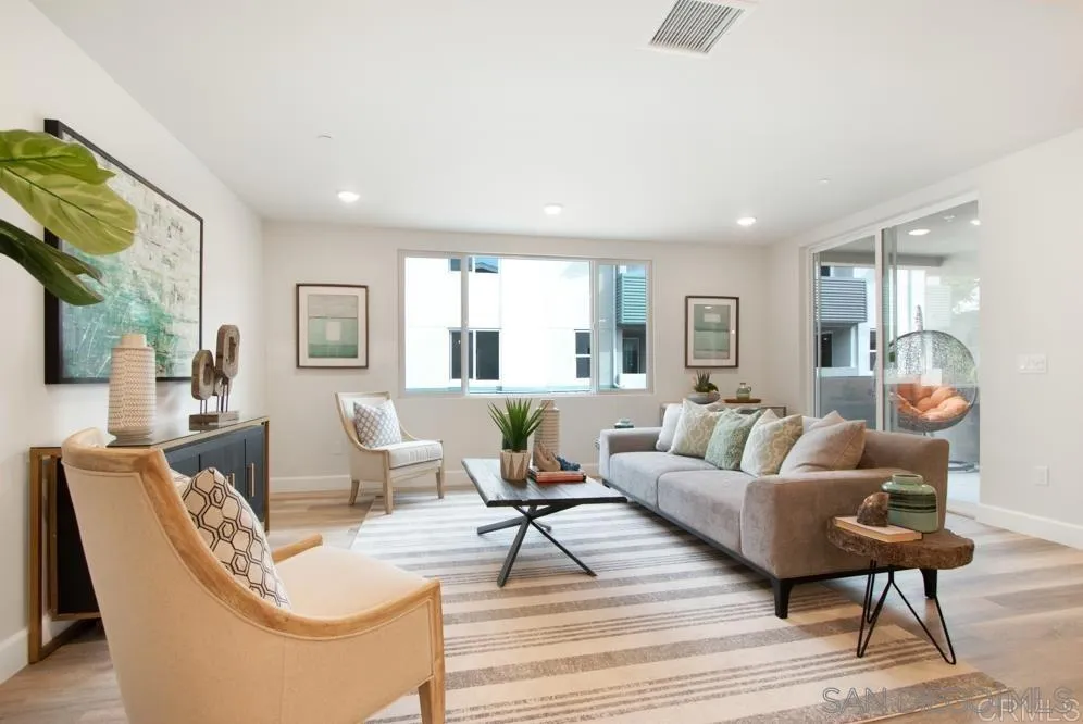 348 Walnut Avenue Carlsbad, CA 92008 - Photo 6 of 20 a living room with couches coffee table and cabinet next to a window