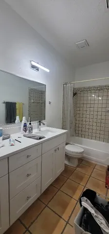 a bedroom with windows and a chandelier