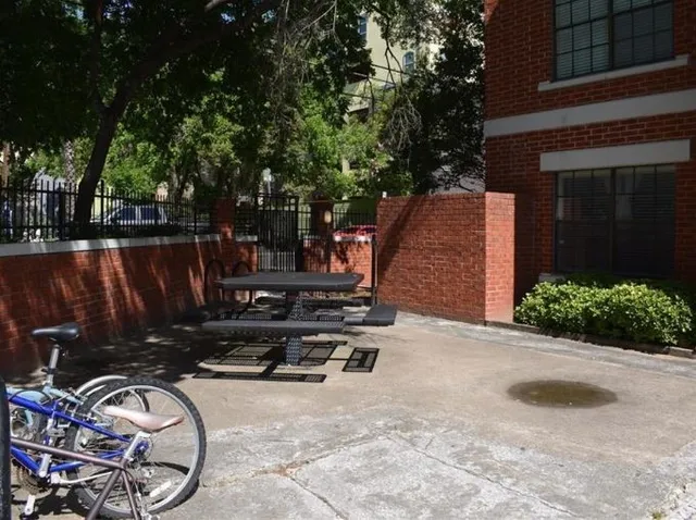 a view of a backyard with table and chairs a barbeque and a stove