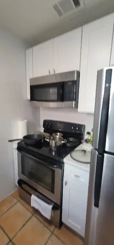 a stove top oven sitting inside of a kitchen