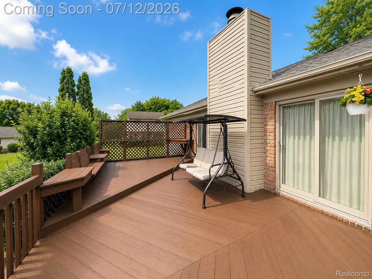 2033 Avonstoke Road Rochester, MI 48307 - Photo 26 of 26 Spacious composite deck featuring built-in bench seating, lattice privacy screening, and direct access through a large sliding glass door
