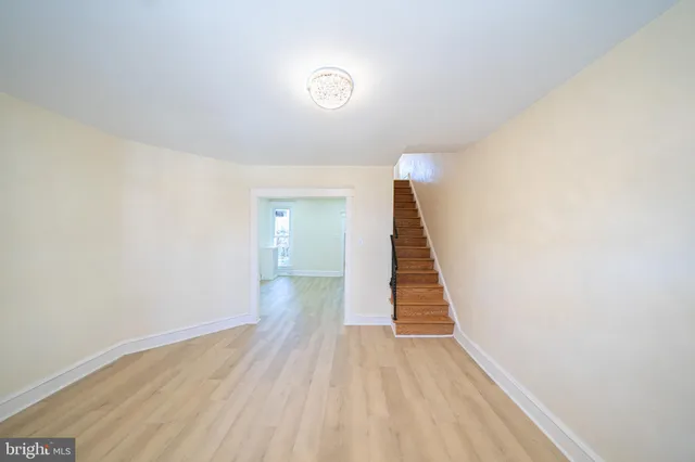a view of a room with wooden floor and stairs