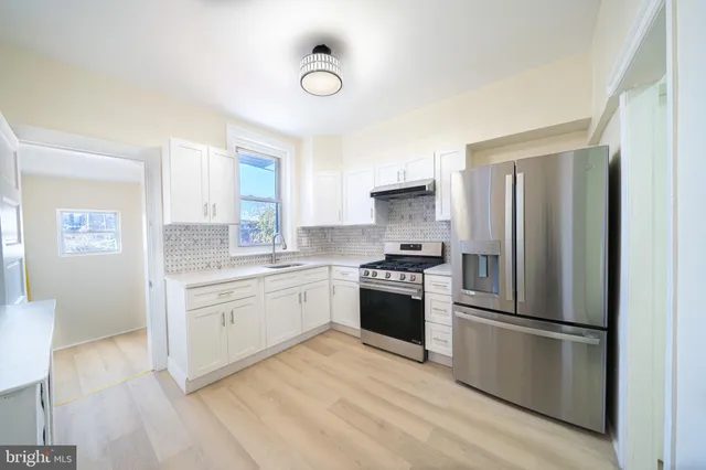 a kitchen with a refrigerator stove and sink