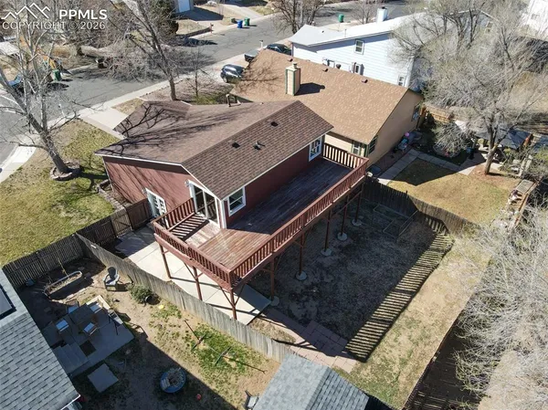 an aerial view of a house with a mountain