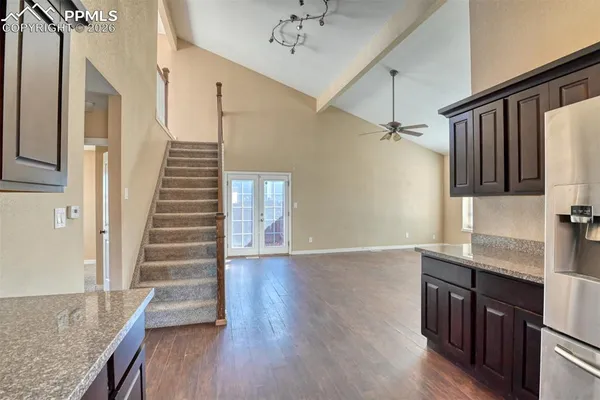 a kitchen with wooden floor and entryway