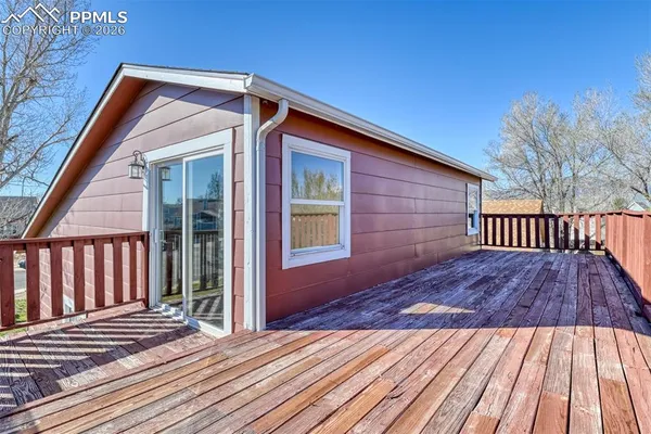 a view of wooden house and a yard