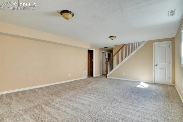 a view of an empty room with stairs