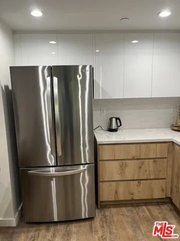 a kitchen with a refrigerator and cabinets