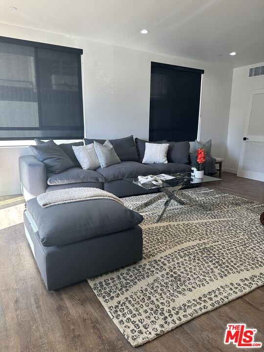 124 South Croft Avenue, Unit 101 Los Angeles, CA 90048 - Photo 18 of 22 a living room with furniture and a flat screen tv