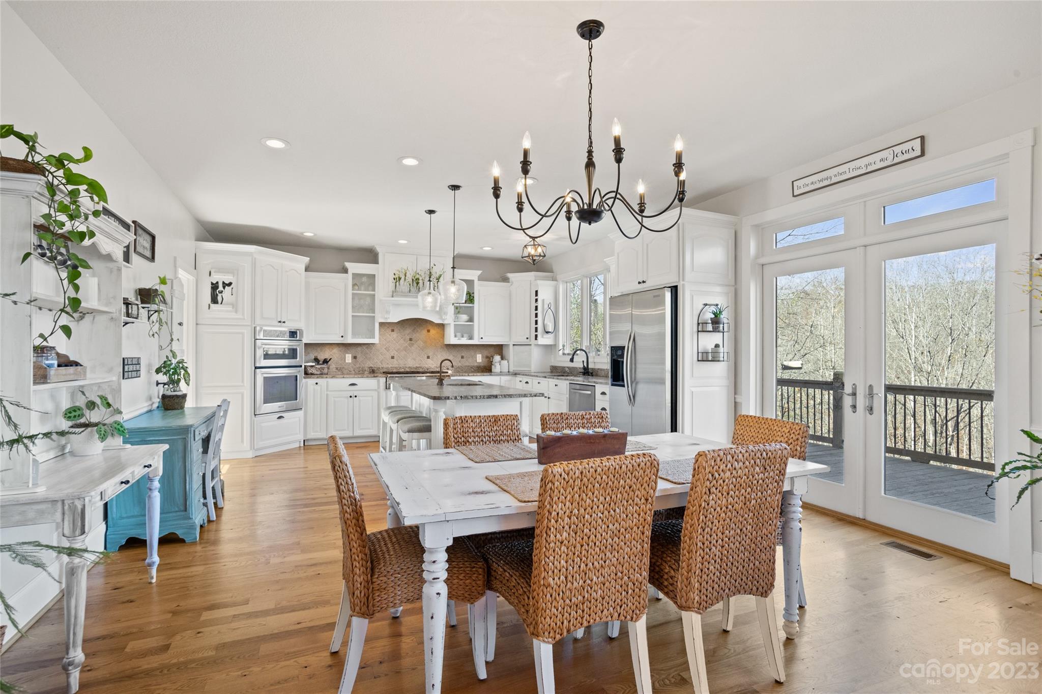 340 Highland View Lane Mill Spring, NC 28756 - Photo 15 of 48 a view of a dining room and livingroom with furniture wooden floor a chandelier