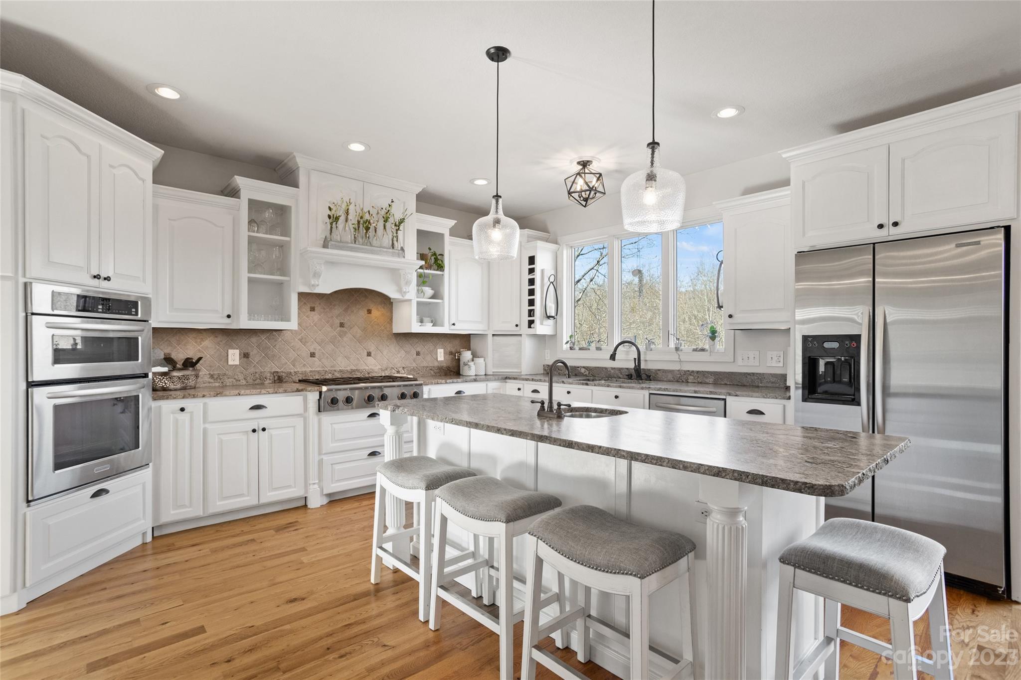 340 Highland View Lane Mill Spring, NC 28756 - Photo 17 of 48 a kitchen with stainless steel appliances granite countertop a sink a stove and a refrigerator