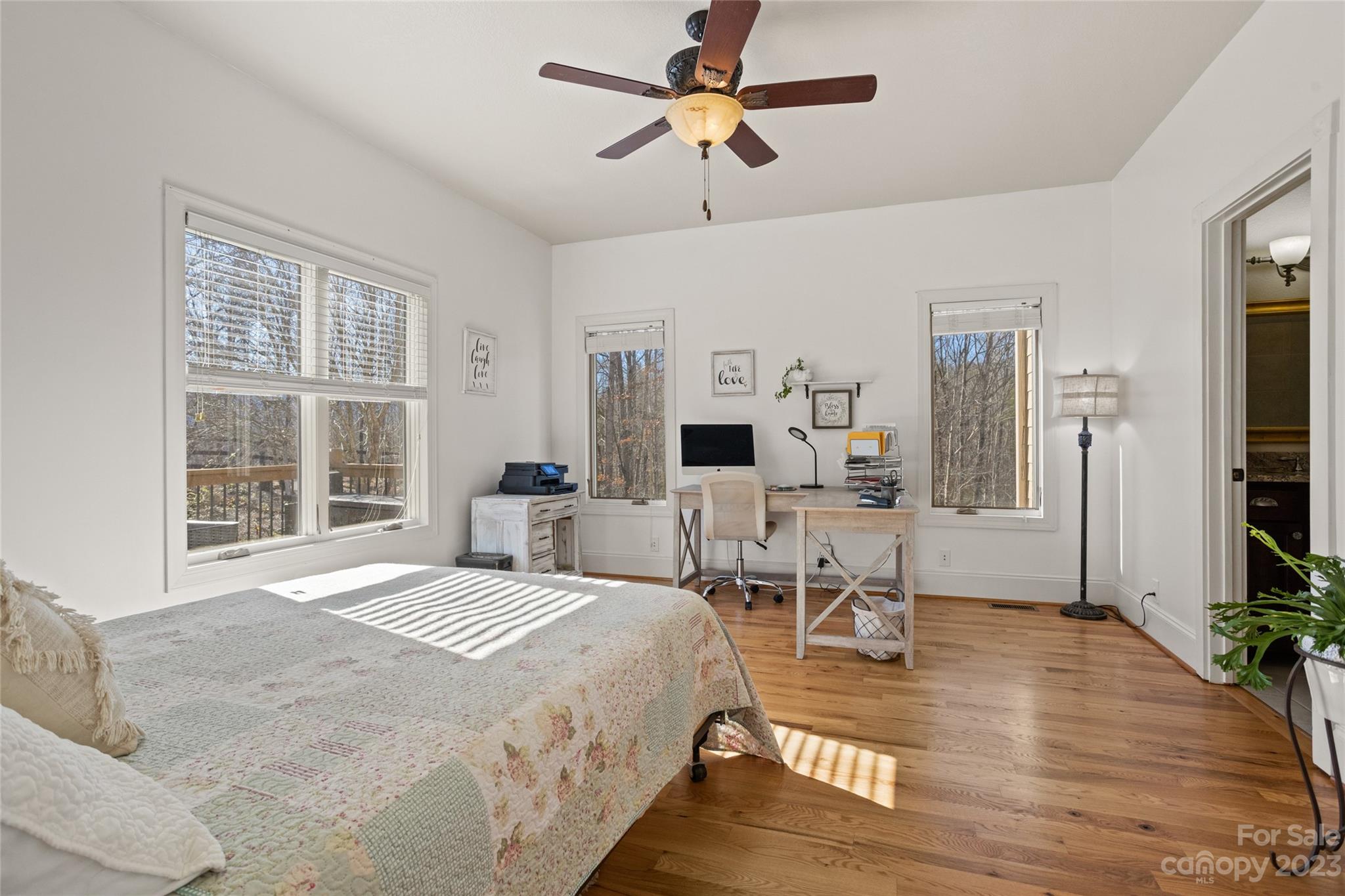 340 Highland View Lane Mill Spring, NC 28756 - Photo 25 of 48 a bedroom with a bed a large window and potted plant on the dresser
