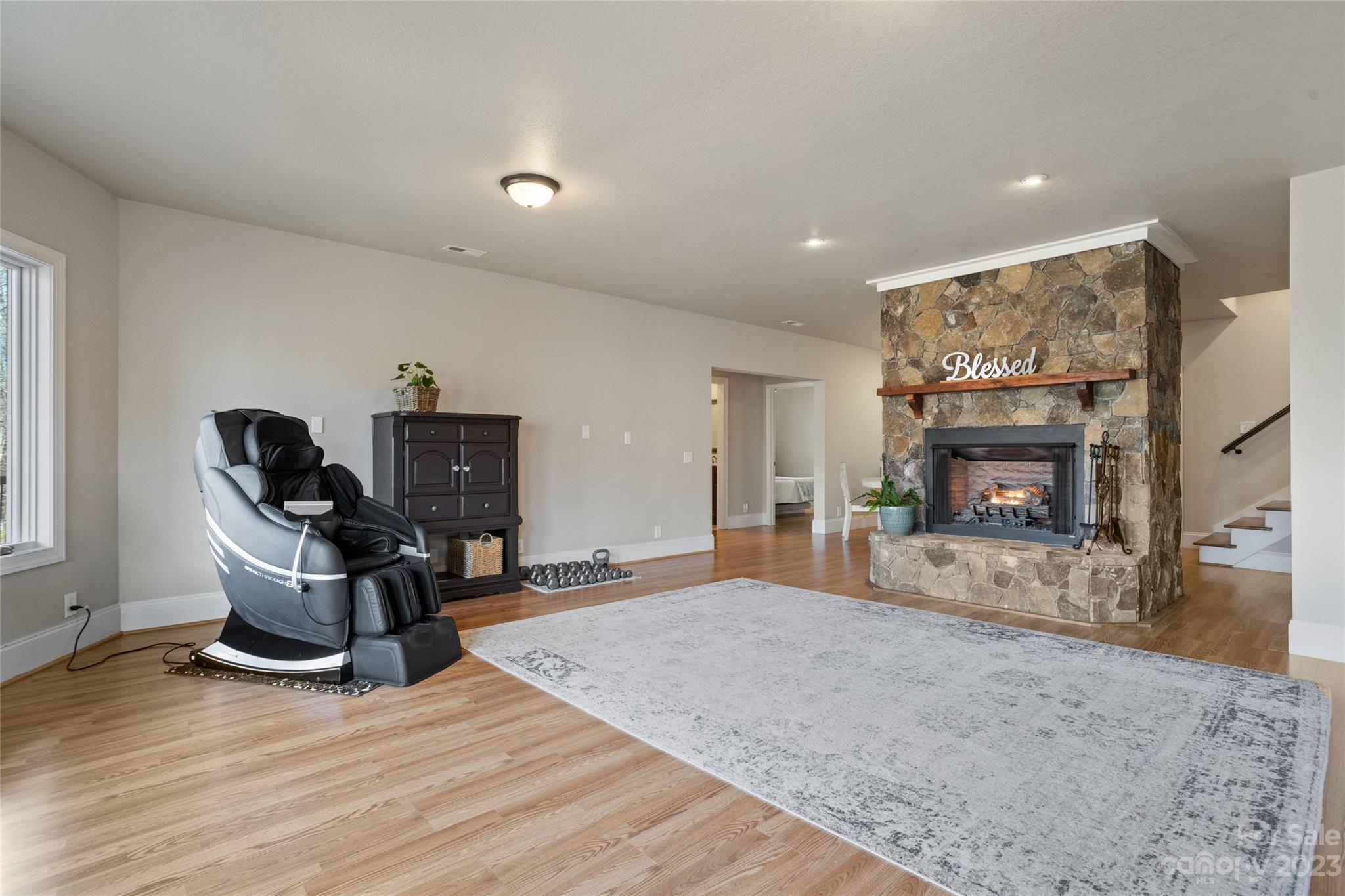 340 Highland View Lane Mill Spring, NC 28756 - Photo 32 of 48 a living room with furniture a fireplace and a flat screen tv