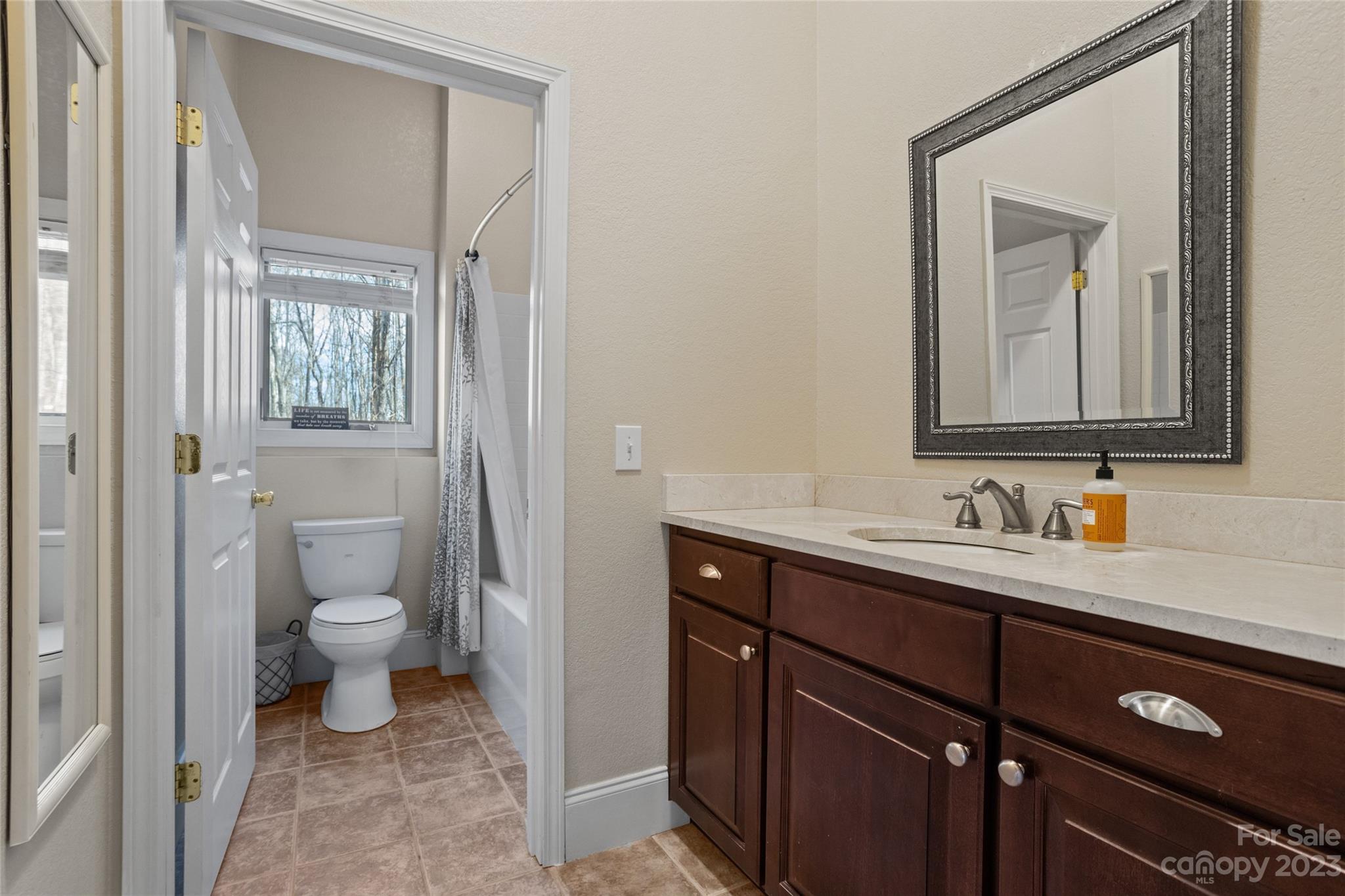 340 Highland View Lane Mill Spring, NC 28756 - Photo 33 of 48 a bathroom with a toilet sink and mirror