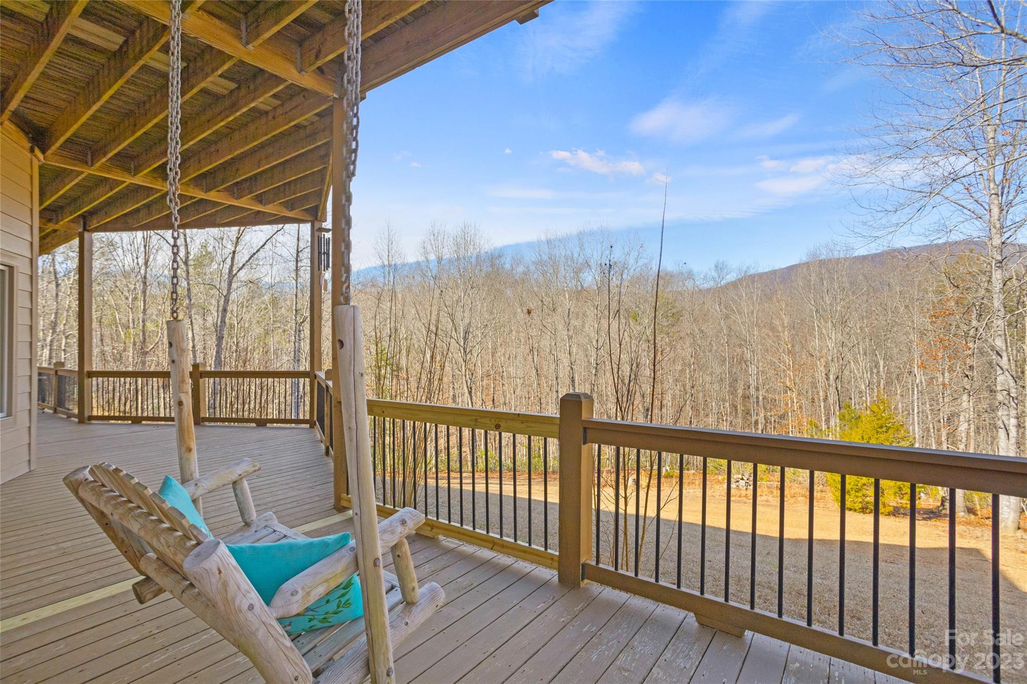 340 Highland View Lane Mill Spring, NC 28756 - Photo 38 of 48 a view of a balcony with table and chairs and wooden floor