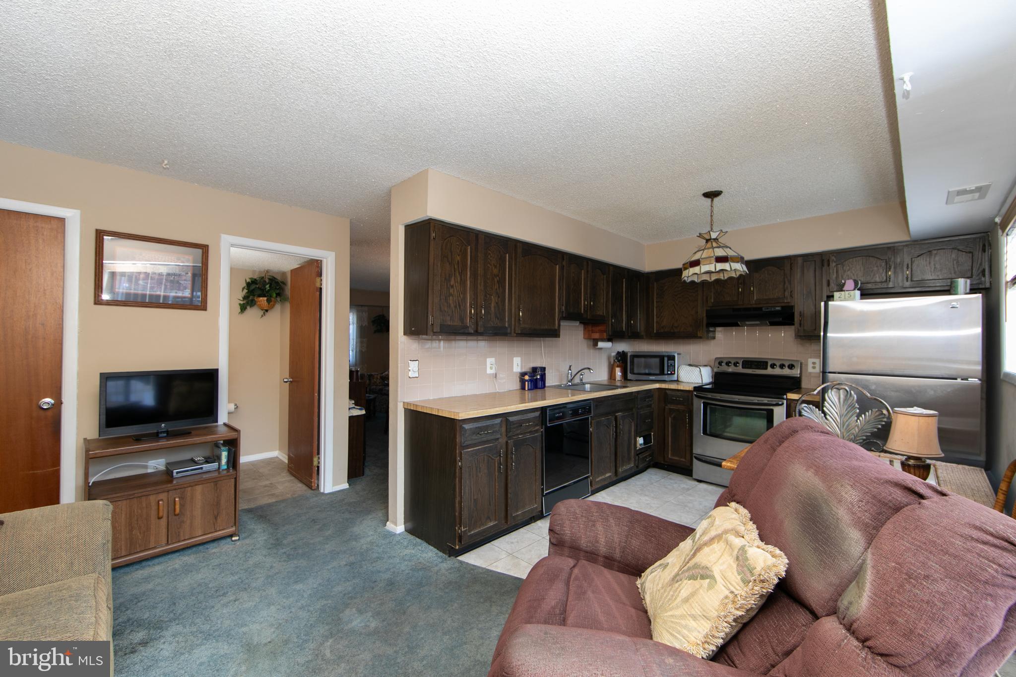 29 Chiswick Drive Lindenwold, NJ 08021 - Photo 11 of 26 a kitchen with a refrigerator and a stove top oven
