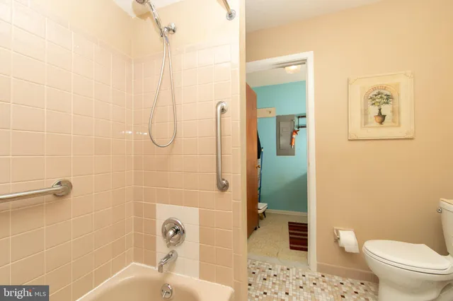 a bathroom with a toilet and shower