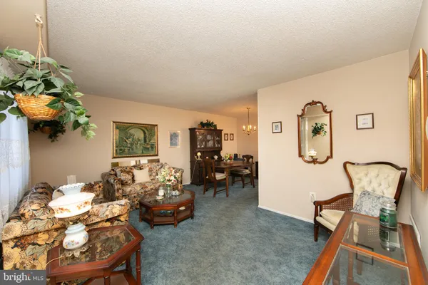 a bedroom with furniture and a chandelier