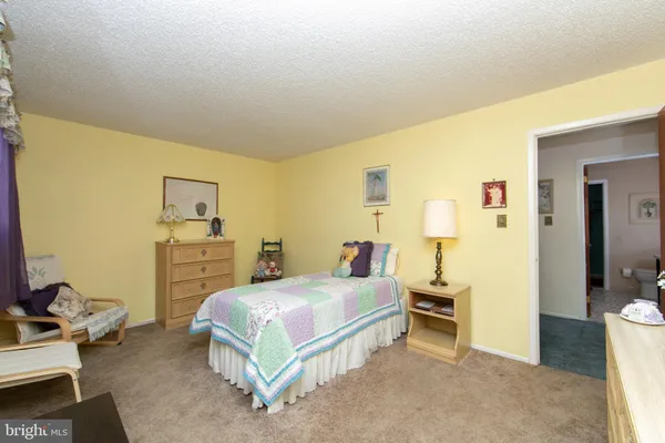 a bedroom with a bed and a table in it