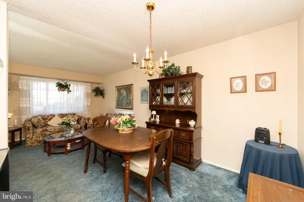 a view of a dining room with furniture and chandelier