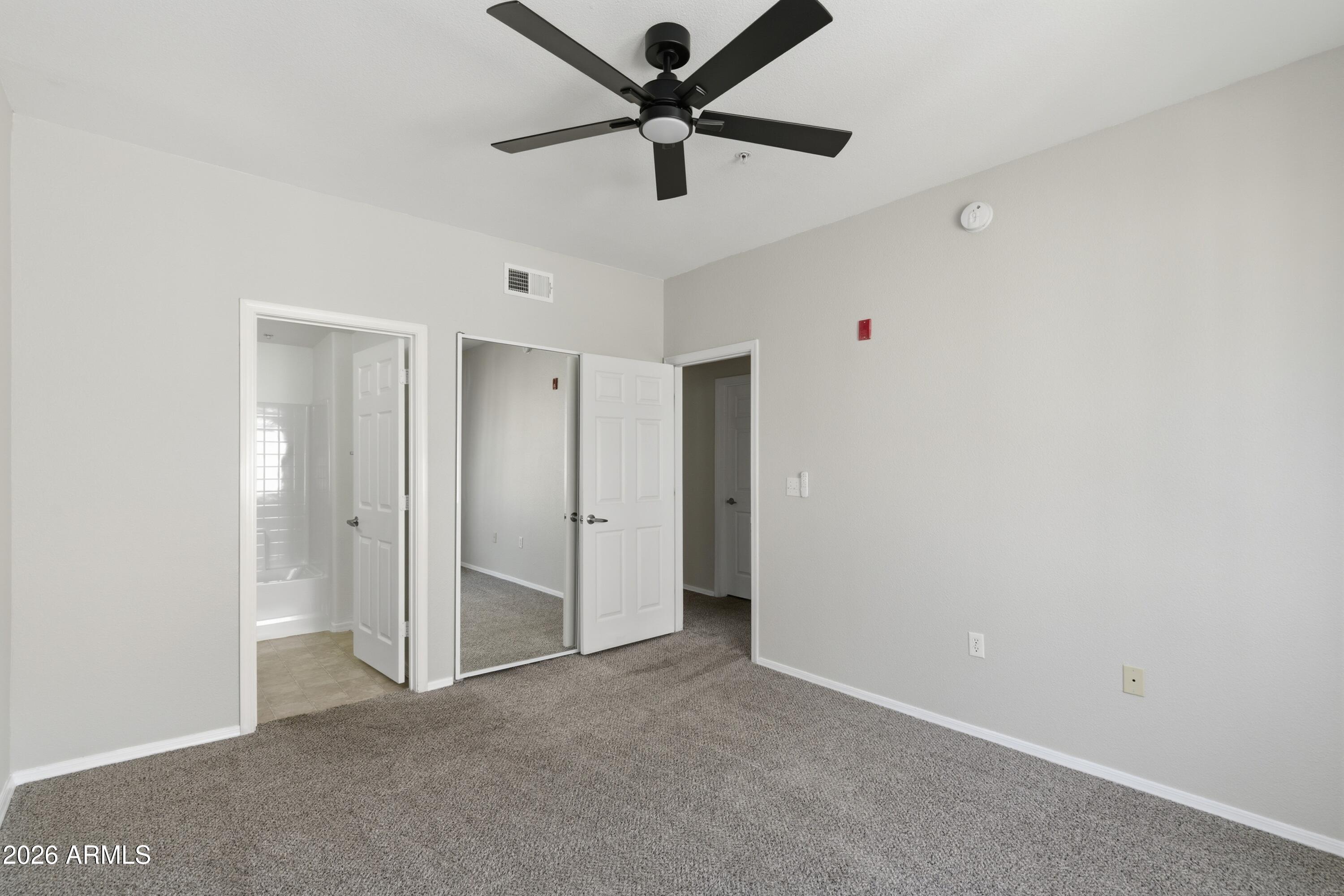 18416 North Cave Creek Road, Unit 3057 Phoenix, AZ 85032 - Photo 11 of 21 a view of a livingroom with a ceiling fan and a window