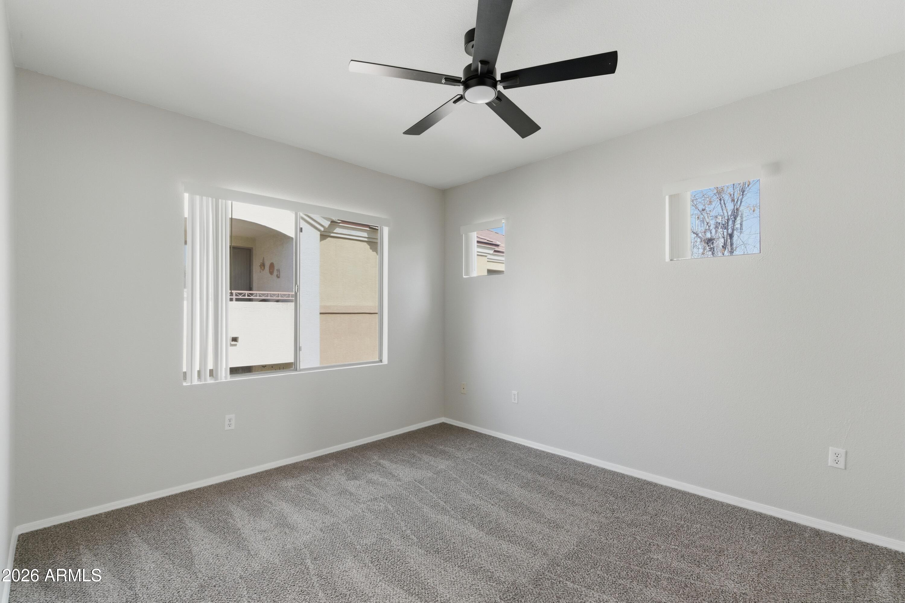 18416 North Cave Creek Road, Unit 3057 Phoenix, AZ 85032 - Photo 13 of 21 an empty room with a window and a fan