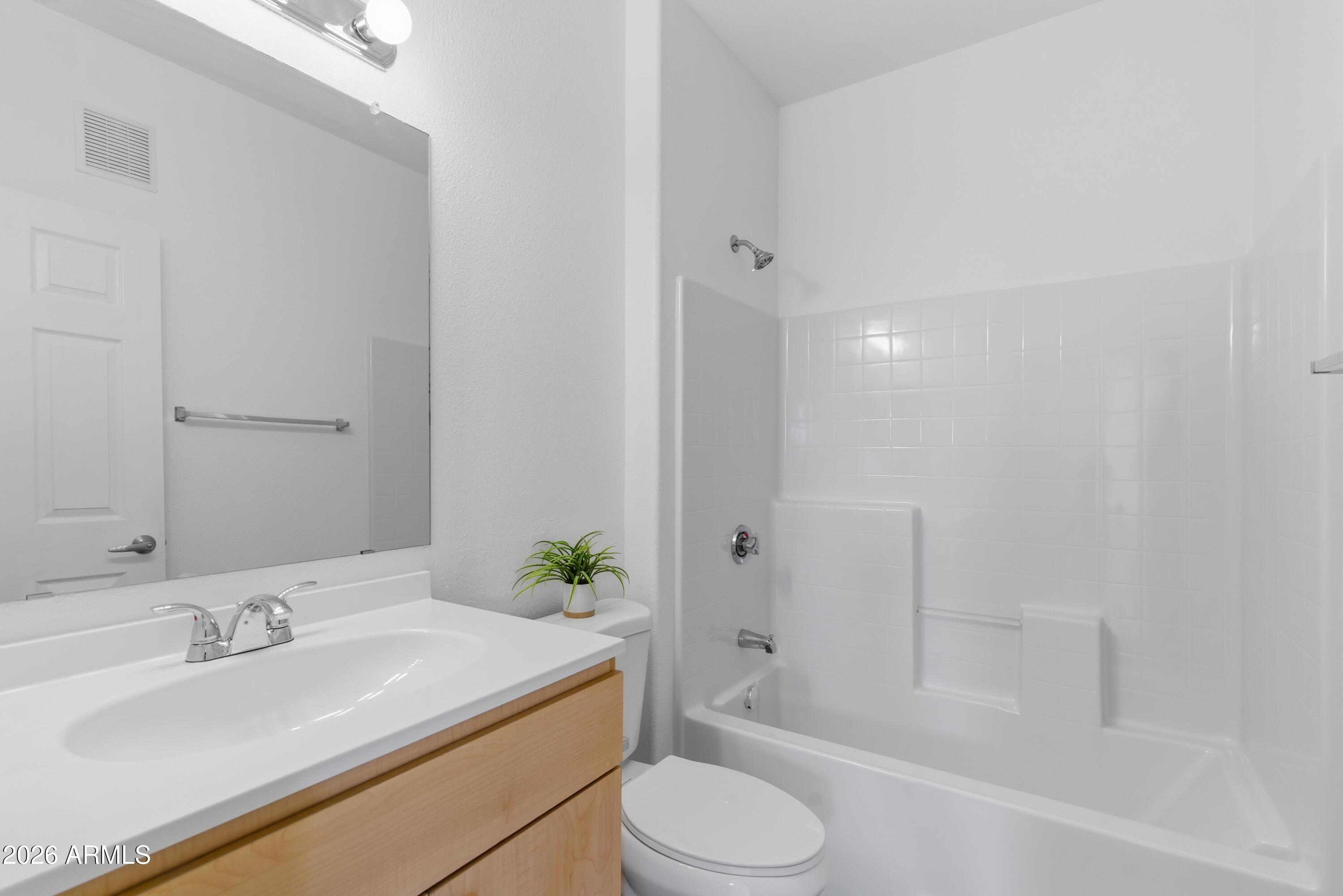 18416 North Cave Creek Road, Unit 3057 Phoenix, AZ 85032 - Photo 15 of 21 a bathroom with a sink toilet and shower