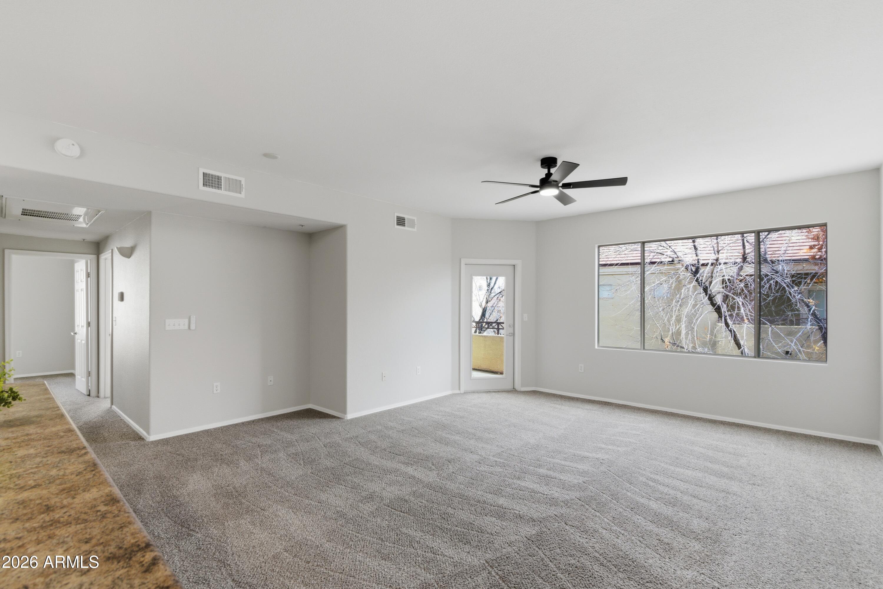 18416 North Cave Creek Road, Unit 3057 Phoenix, AZ 85032 - Photo 5 of 21 a view of an empty room with a window