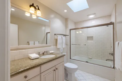 a front view of a house with garden space and street view