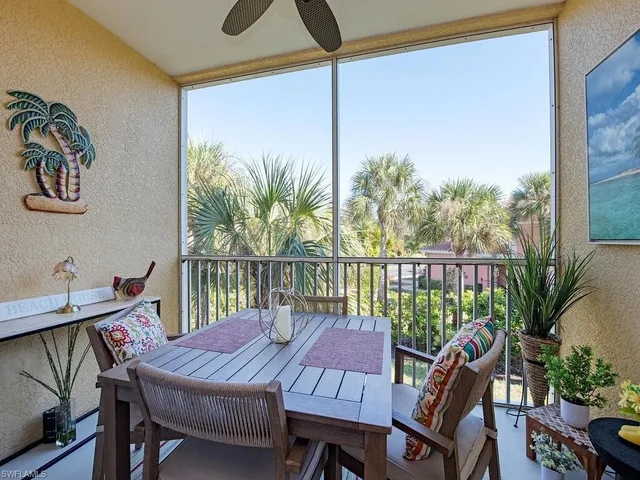 a view of a balcony dining area with furniture