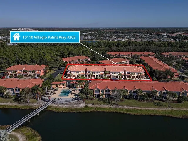 a view of a city with lots of residential buildings ocean and mountain view