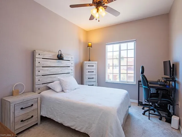 a bedroom with a bed and a desk